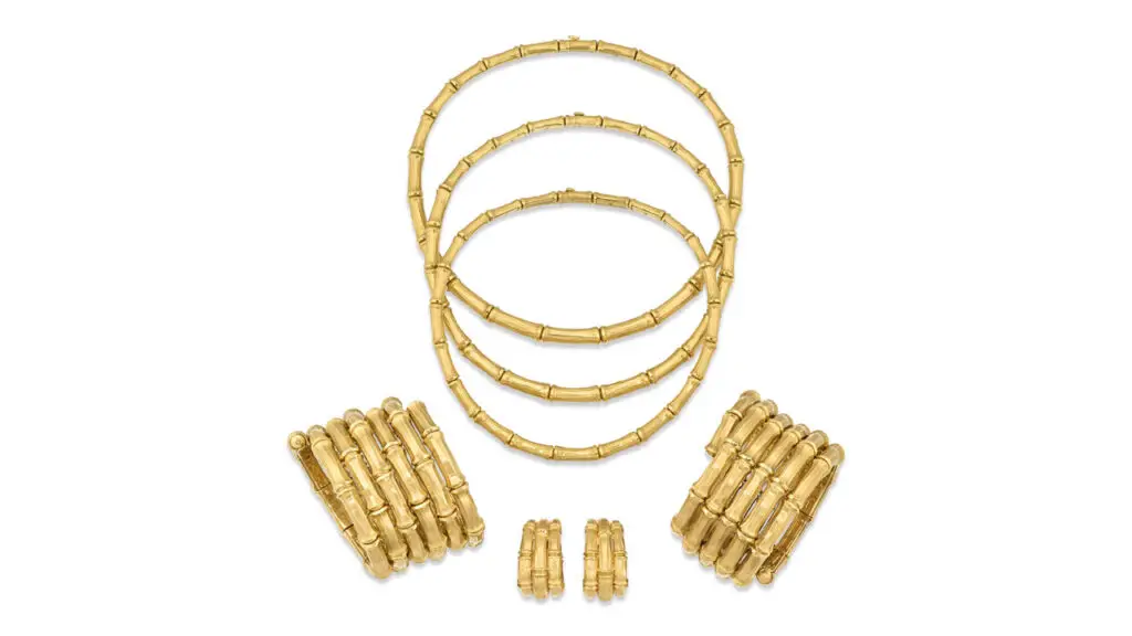 A Cartier jewel set designed as bamboo includes three graduating necklaces, two bangles and a pair of earrings at Christie's image