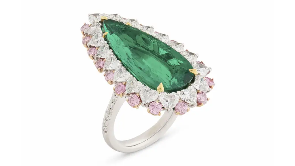 A ring bearing a pear-cut, 9.09-carat Colombian emerald, in a frame of white round and heart-shaped diamonds and round and marquise-shaped colored diamonds at Christie's image