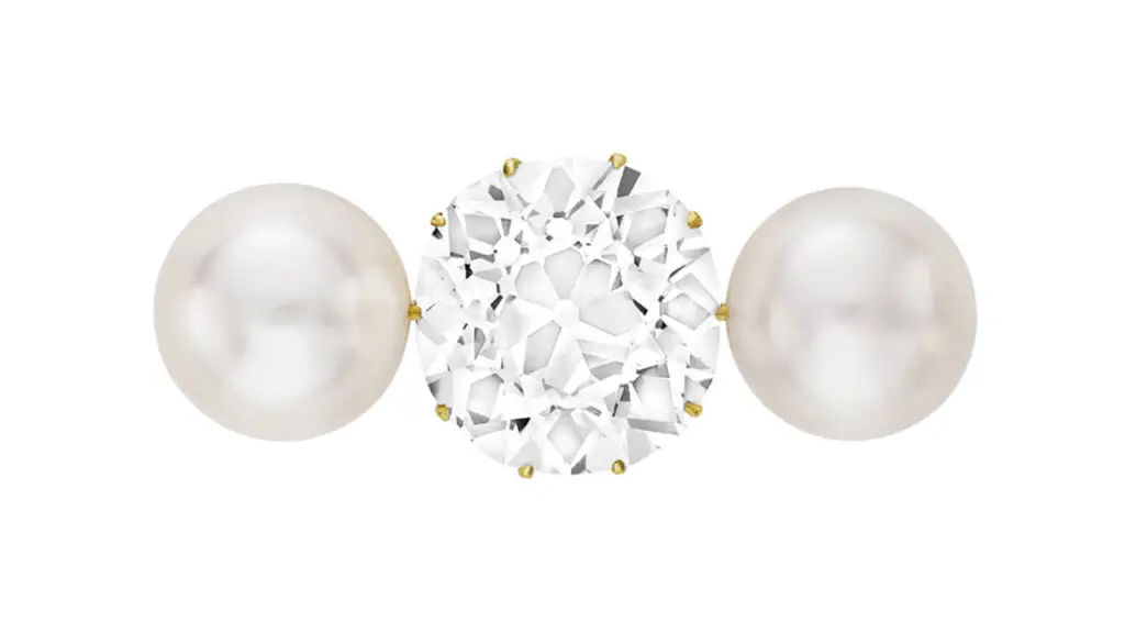 This brooch from around 1900 centers an old mine brilliant-cut, 18.27-carat, D, SI1 diamond between two button-shaped natural saltwater pearls at Christie's image