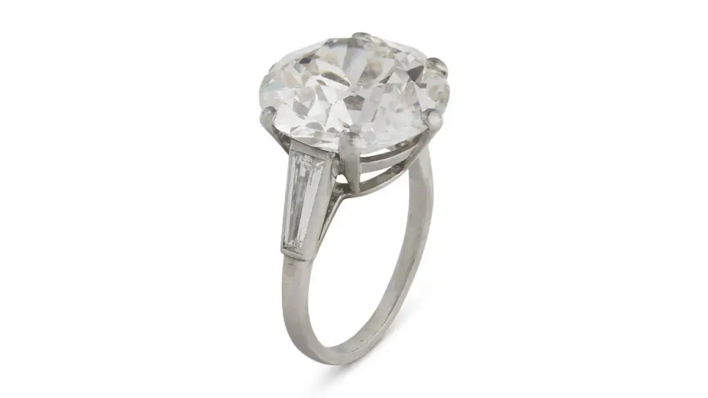 A ring with a round, 11.51-carat, I, SI1 diamond between trapeze baguette-cut diamonds at Christie's image