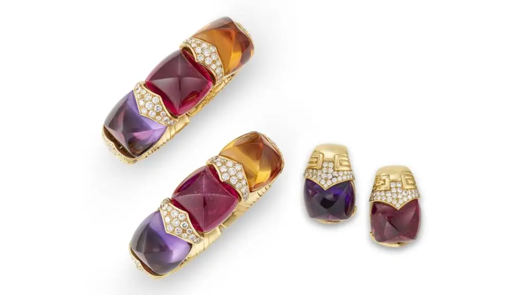A Bulgari multi-gem set including bangles and a pair of earrings features sugarloaf citrines, tourmalines, amethysts and round diamonds at Christie's image