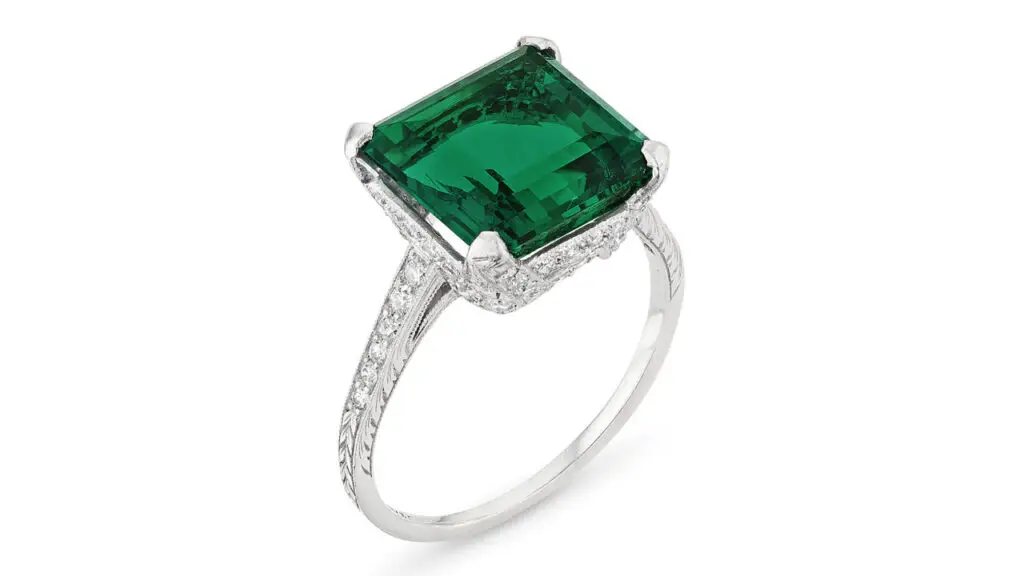 A Tiffany & Co. Art Deco ring from 1925 centers a modified square step-cut, 6.01-carat Colombian emerald, with old-cut diamonds at Christie's image