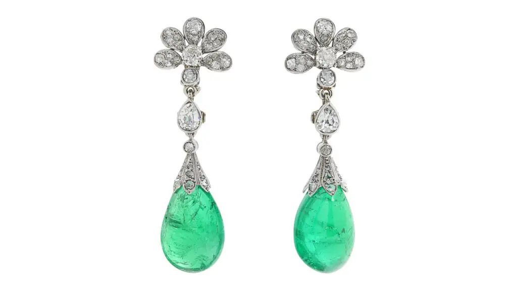A pair of Chaumet earrings sporting two drop-shaped, Colombian emeralds with a total weight of around 40 carats, suspended from pear-shaped, old- and rose-cut diamonds at Christie's image