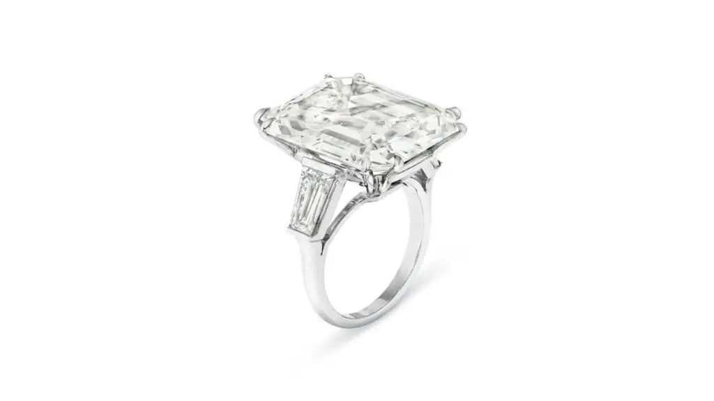 A ring bearing an emerald-cut, 24.99-carat, J-color, VS1-clarity diamond with baguette-cut diamond shoulders at Christie's image