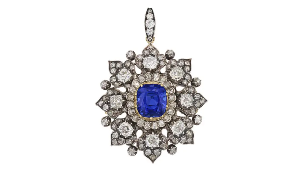 This brooch, created circa 1890, contains an antique cushion-shaped, 10.38-carat Kashmir sapphire, surrounded by old cushion-shaped diamonds, and can also be worn as a pendant or bracelet at Christie's image