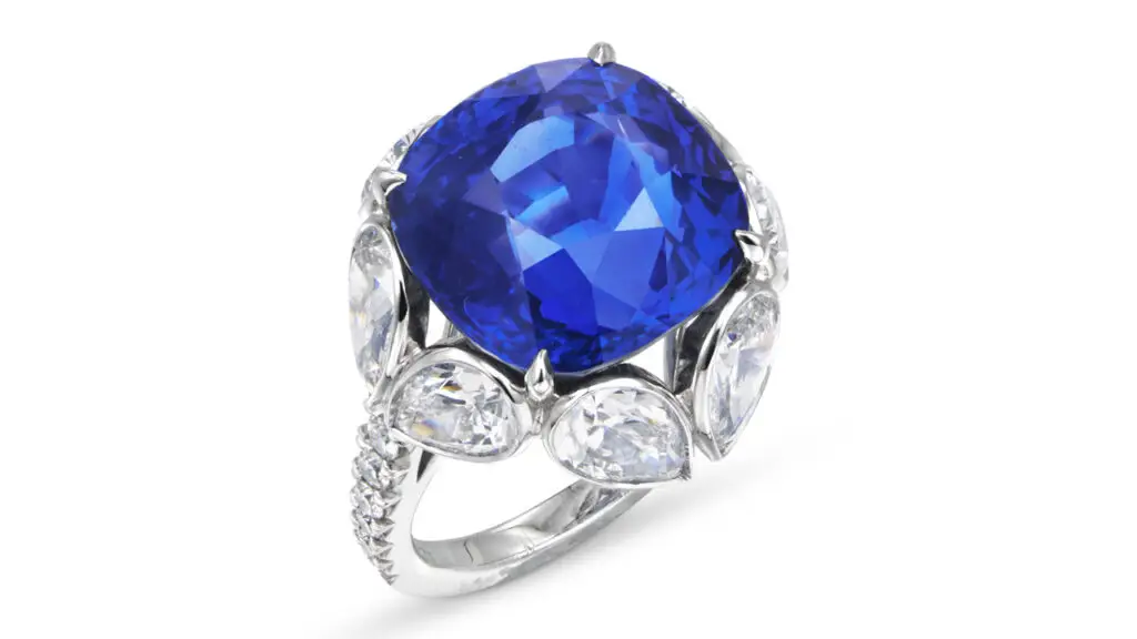 A ring featuring a cushion-shaped, 15.28-carat Sri Lankan sapphire, a circle of pear-shaped diamonds, and round-diamond accents on the band at Christie's image