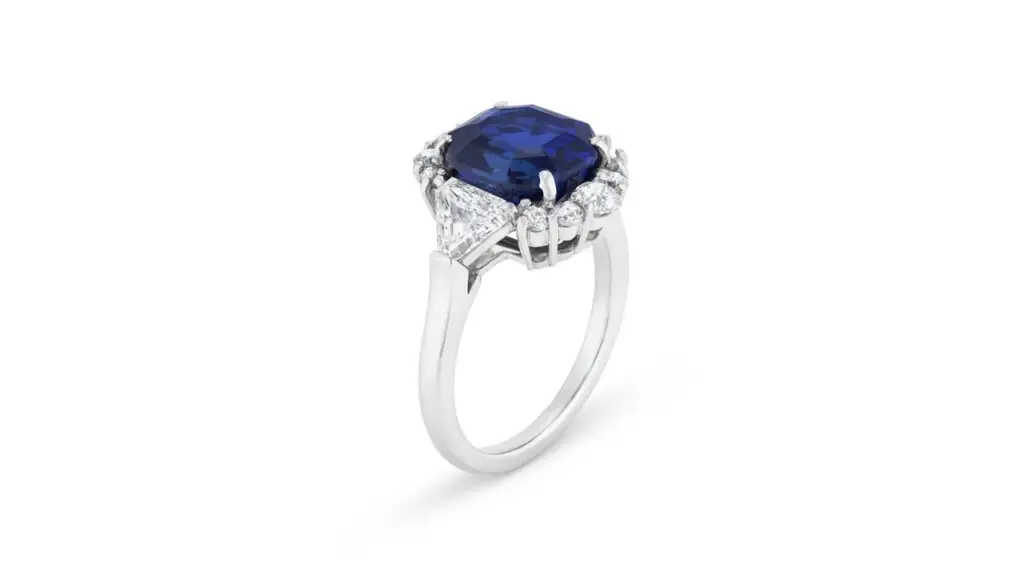 This ring features a modified octagonal step-cut, 5.82-carat Kashmir sapphire between triangular-shaped diamonds at Christie's image
