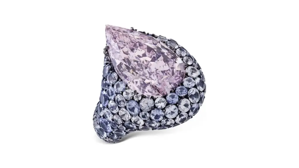 A JAR ring featuring a pear modified brilliant-cut, 8.68-carat, fancy-purplish-pink, VVS1-clarity diamond in a sapphire and diamond surround at Christie's image