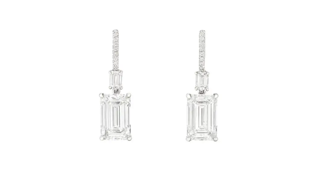 A pair of earrings comprising emerald-cut diamonds, one a 5.03-carat, D, VS1 and the other a 5.02-carat, E, VVS1 stone, both suspended from emerald-cut and round diamonds at Christie's image