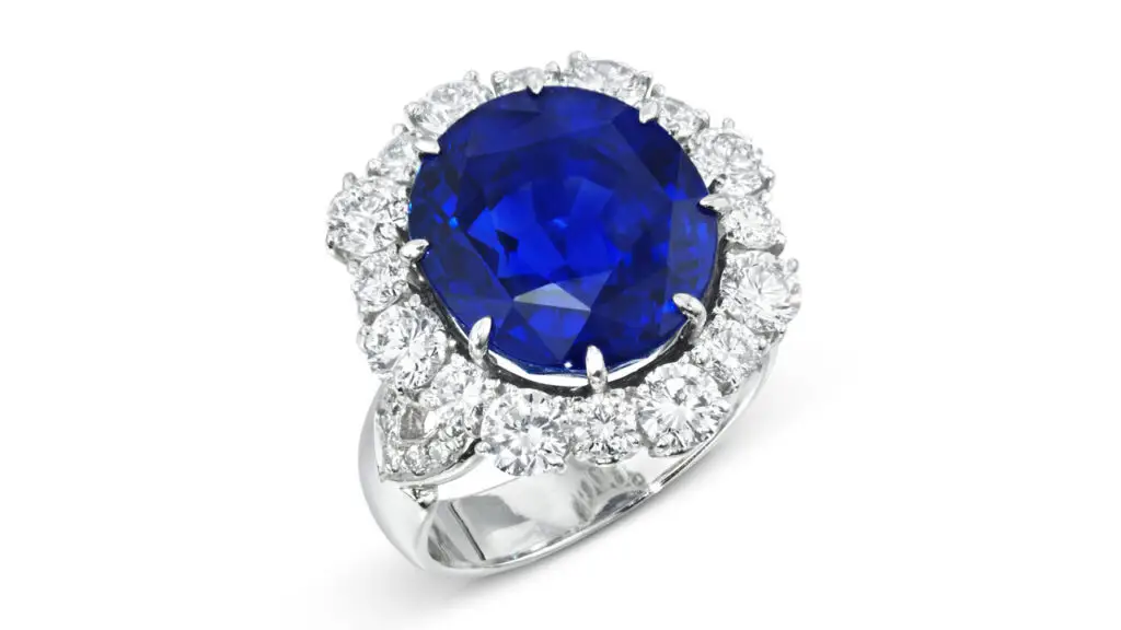 This oval-cut, 12.21-carat Ceylon sapphire in a ring with a border of round diamonds at Christie's image