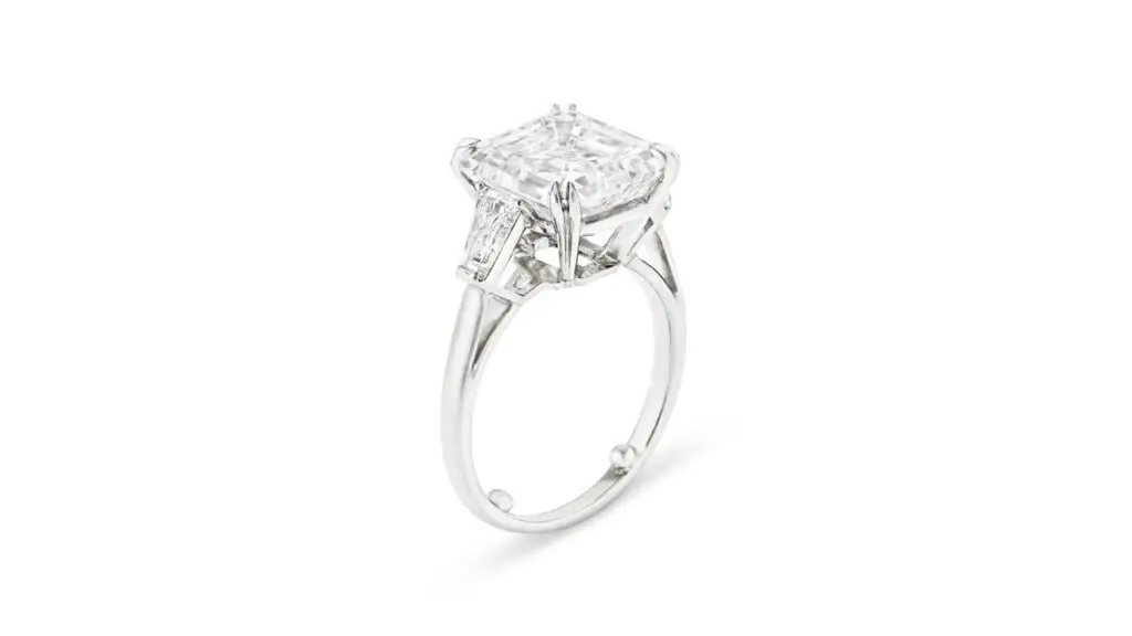 A Tiffany & Co. ring with a square emerald-cut, 7.05-carat, E, VS2 diamond and tapered baguette-cut stones at Christie's image