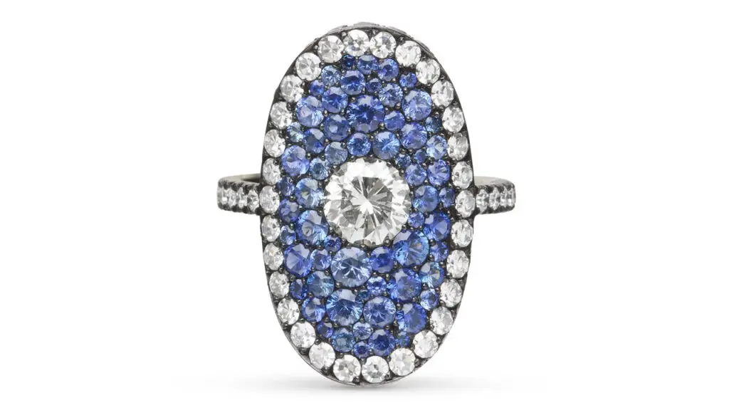 A JAR ring centers a round diamond, framed by 2.80 carats of sapphires, with a border of round and single-cut diamond weighing a total of 2.10 carat Christie's image
