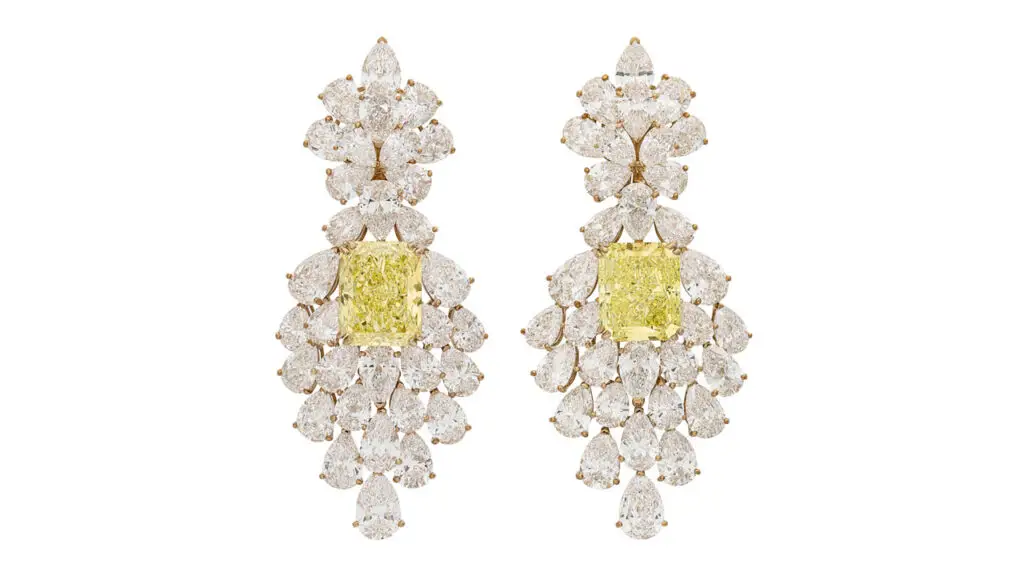 Van Cleef & Arpels made these earrings, each containing a cushion rectangular modified brilliant cut diamond — one a 19.33-carat, fancy-vivid-yellow, and the other an 18.03 carat, fancy-intense-yellow — with pear-brilliant-cut diamonds weighing 2.60, 2.11 and 2.09 carats at Christie's image