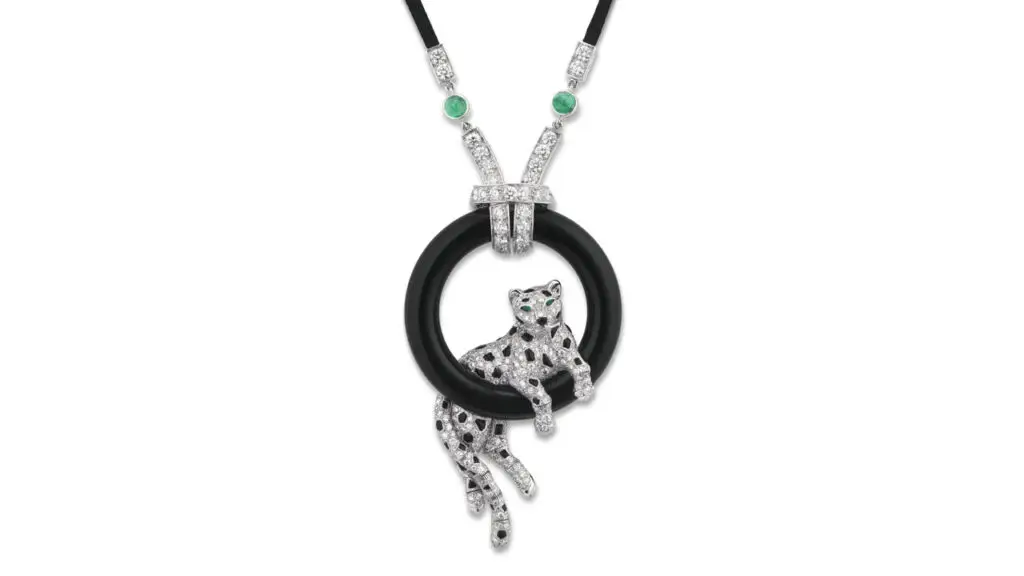 This Cartier pendant sports a diamond panther on an onyx hoop, with onyx spots and pear-shaped emerald eyes at Christie's image