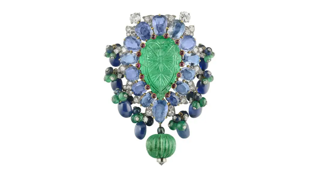 From Cartier, this Tutti Frutti clip brooch features carved emerald, emerald and sapphire beads, cabochon and oval-shaped sapphires, cabochon rubies, and round and single-cut diamonds at Christie's image