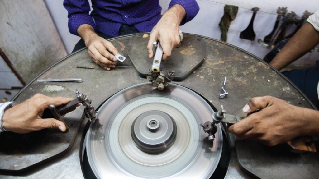 Diamond polishers at the wheel in Surat image