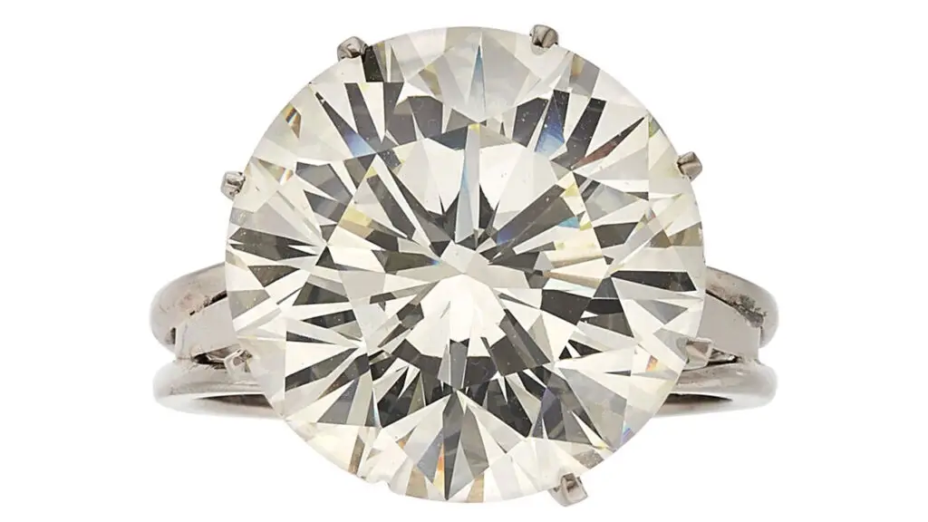 A ring centering a round brilliant-cut, 12.90-carat, M, VS2 diamond at Heritage Auctions image