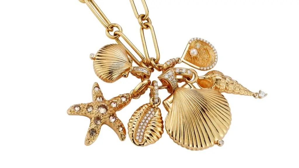 Gold chain with an assortment of gold and diamond sea inspired pendants image