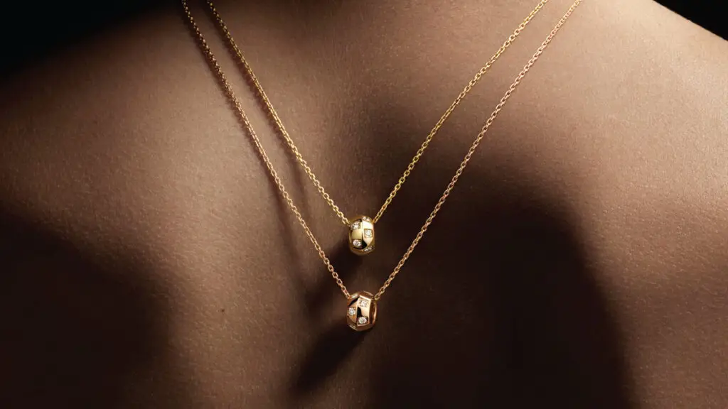 Louis Vuitton gold and diamond Le Damier necklaces on a model’s back image