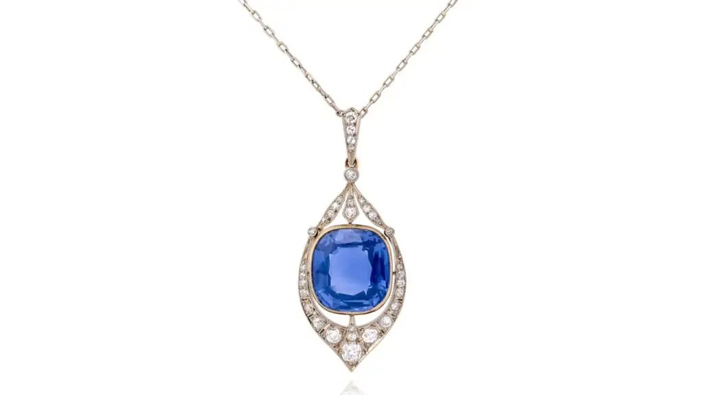 A necklace with an openwork-design pendant sports a cushion-shaped Ceylon color-change sapphire accented with circular-cut diamonds at Phillips image