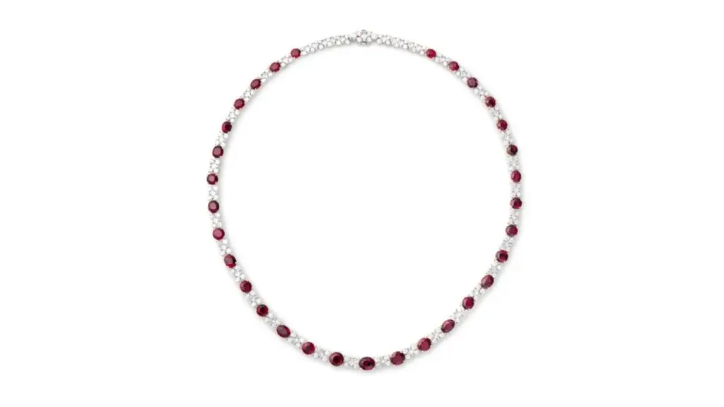 A necklace containing approximately 22 carats of oval and circular-cut Burmese rubies, accented with 7 to 9 carats of brilliant- and princess-cut diamonds at Phillips auction image