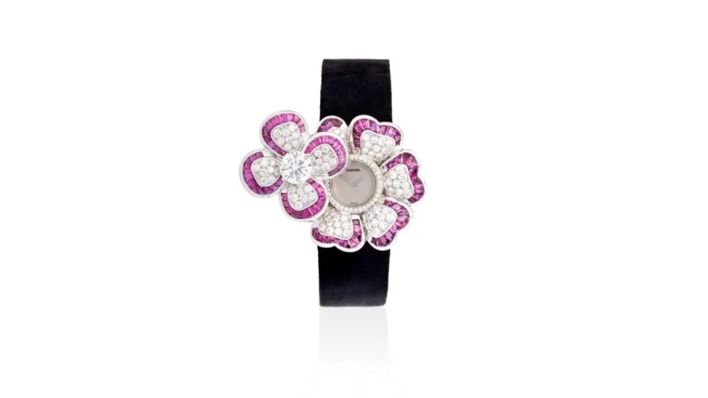 This Chanel Camélia wristwatch displays two flower motifs, one with a brilliant-cut, 1.59-carat diamond. Both flowers feature petals decorated with calibré-cut rubies and brilliant-cut diamonds at Phillips auction image