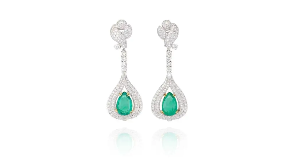 A pair of emerald earrings, each has a pear-shaped Colombian emerald, one weighing 5.11 and the other 5.17 carats, accented with around 8 carats of pear-shaped, brilliant-cut and tapered baguette diamonds at Phillips auction image