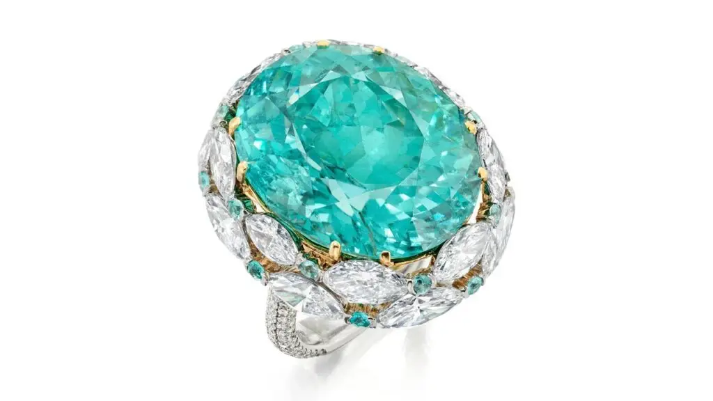 A ring bearing an oval, 31.77-carat Mozambique Paraiba tourmaline, embellished by rows of marquise-shaped diamonds and circular-cut blue tourmalines, and with brilliant-cut diamonds on the band at Phillips image