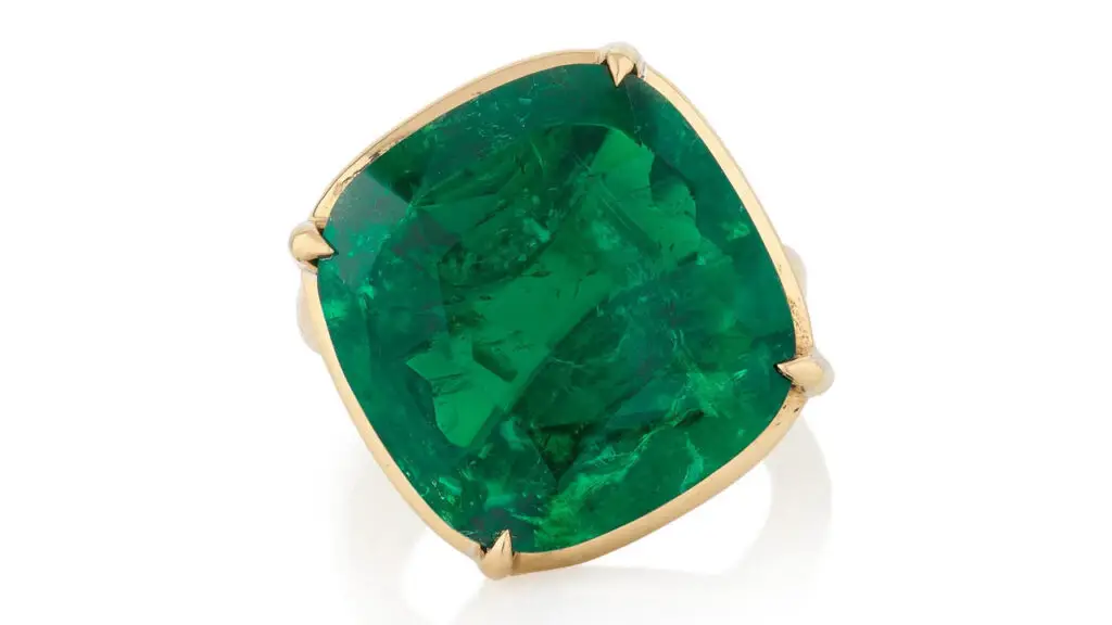 A ring centering a cushion-shaped, 14.69-carat Colombian emerald at Phillips image