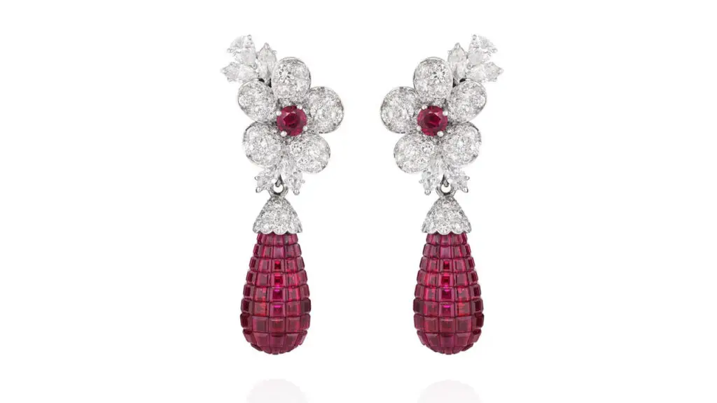 A pair of Van Cleef & Arpels earrings, each sporting a detachable drop-shaped pendant with calibré-cut rubies. These suspend from a floral design featuring pear- and marquise-shaped and brilliant-cut diamonds and accented with a circular-cut ruby at Phillips image