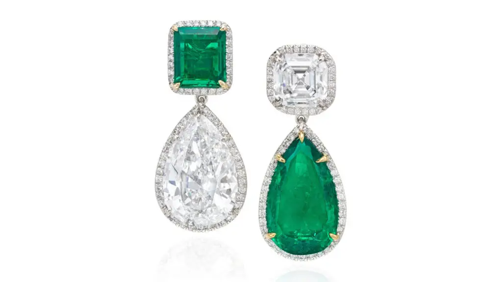 Emerald and diamond earrings, one earring features a pear-shaped, 6.44-carat Colombian emerald hanging from a step-cut, 3.01-carat, D, VS1 diamond, while the other has a 7.45-carat, E, VS1 diamond dangling from a step-cut, 1.93-carat Colombian emerald. Each stone has a frame of circular-cut diamonds at Phillips image