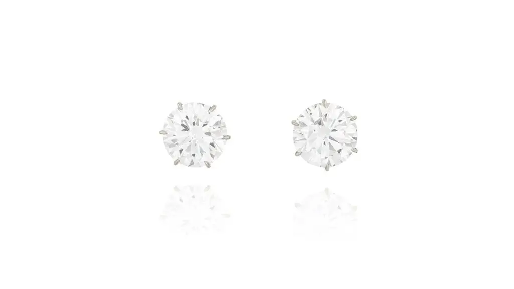 A pair of earrings consisting of brilliant-cut, D-color, VVS1-clarity diamond studs weighing 8.28 and 8 carats at Phillips image