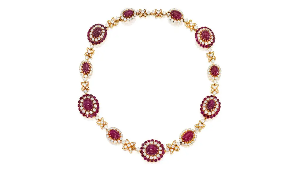 This ruby and diamond Van Cleef & Arpels necklace features cabochon rubies accented by brilliant-cut diamonds and circular-cut rubies at Phillips image