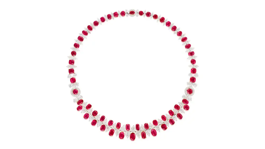 This necklace bears 56.98 carats of oval and cushion-shaped Burmese rubies, spaced by pear-shaped diamonds at Phillips image