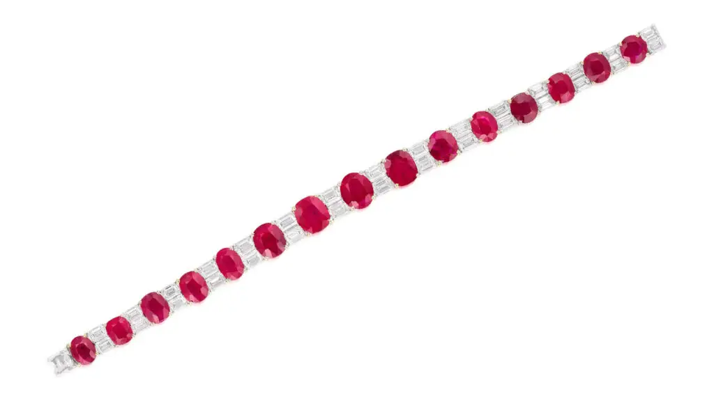 This bracelet features 15 graduated Burmese rubies totaling 30.21 carats, spaced by emerald-cut diamonds at Phillips image