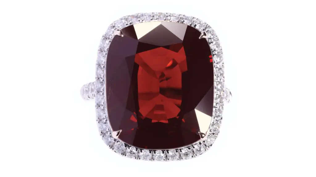 A ring bearing a cushion, 11.12-carat spinel, in a circular-cut diamond frame at Poly Auction image