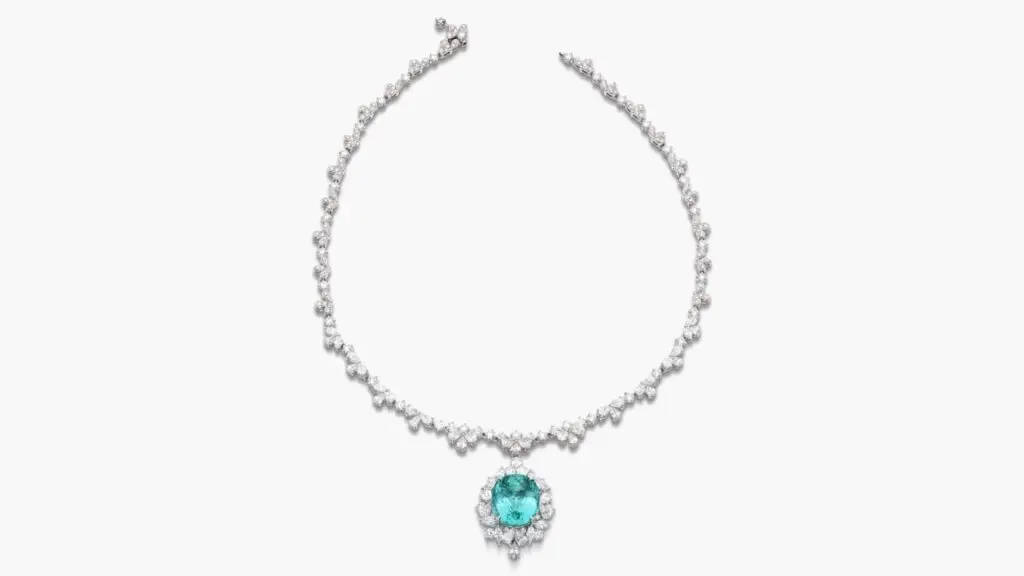 A necklace sporting a detachable pendant with a cushion-shaped, 19.27-carat Nigerian Paraíba tourmaline, framed with pear-, marquise-shaped and brilliant-cut diamonds, and including similarly shaped diamonds along the necklace at Sotheby's image