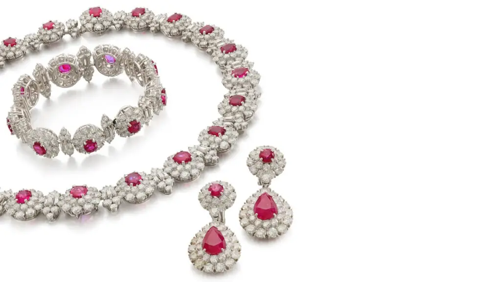 A three-piece ruby and diamond set comprises a necklace featuring cushion-shaped Burmese rubies, within a surround of brilliant-cut and baguette diamonds, a bracelet of matching design and a pair of ear clips with circular-cut and pear-shaped Afghanistan or Vietnamese rubies in a brilliant-cut diamond surround at Sotheby's image