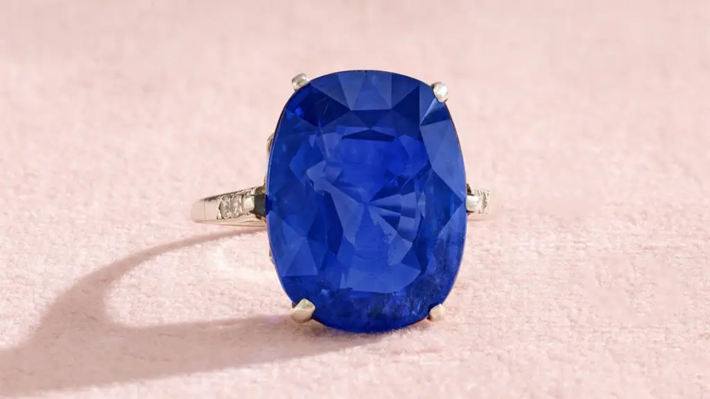 This cushion-shaped, 21.47-carat Sri Lankan sapphire ring with old brilliant-cut diamond shoulders at Sotheby's image