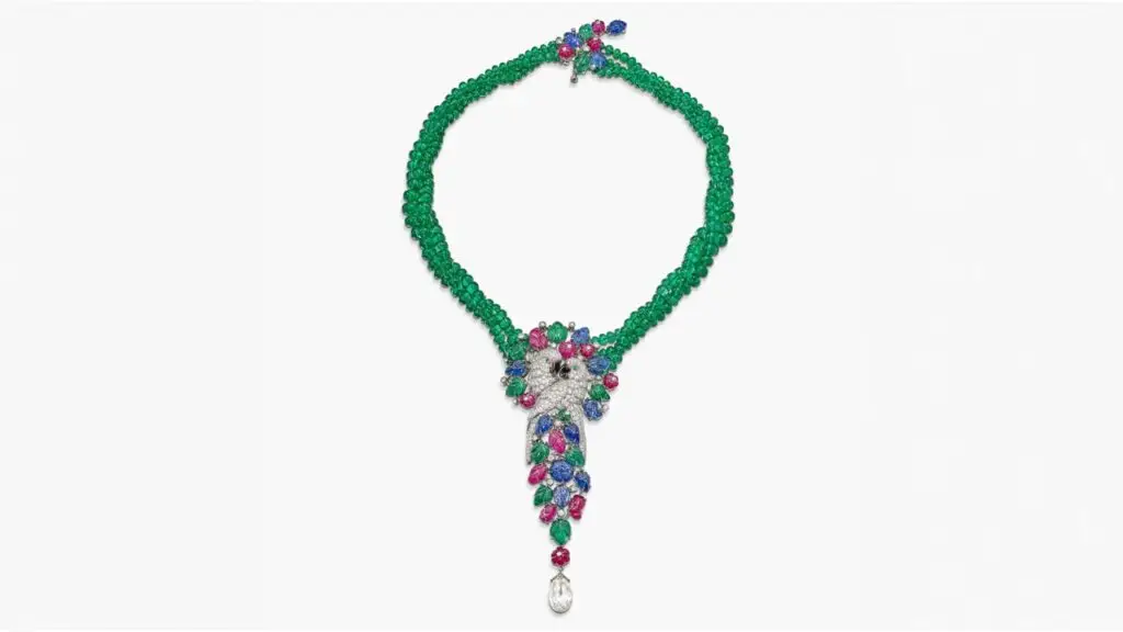 A Cartier tutti frutti necklace designed as a pair of embracing parrots, featuring brilliant-cut diamonds and a diamond briolette, as well as emeralds, mother-of-pearl, rubies and sapphires at Sotheby's image