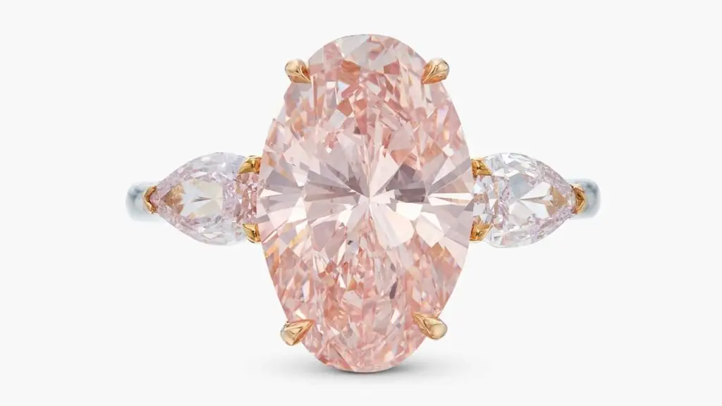 A ring starring an oval-shaped, 5.02-carat, fancy-intense-pink, internally flawless diamond, between two pear-shaped, light-pink diamonds at Sotheby's image