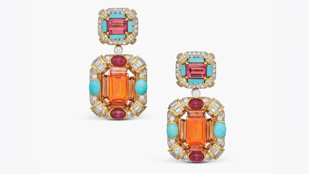 A pair of David Webb ear clips feature detachable pendants with 8.10 carats of emerald-cut fire opals, in a surround containing baguette tourmalines, oval-shaped ruby and turquoise cabochons. The surmounts include emerald-cut tourmalines and rectangular turquoises, accented throughout with 8.50 carats of round and baguette diamonds of F to G color and VS clarity at Sotheby's image