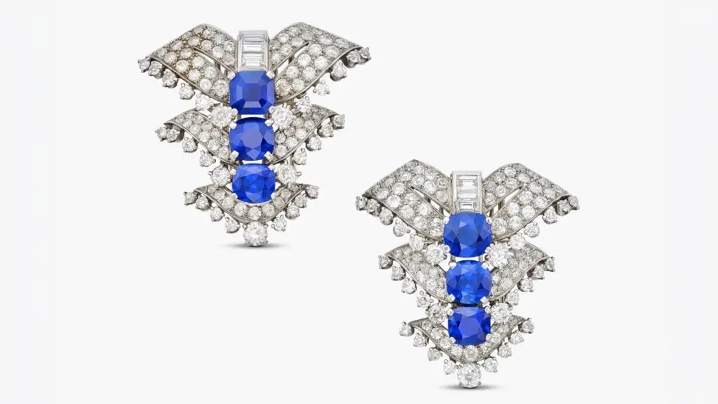 A pair of Cartier clips from 1935, comprising one emerald-cut and five cushion-cut Kashmir sapphires with a total weight of 23.02 carats and old European- and single-cut and baguette diamonds at Sotheby's image