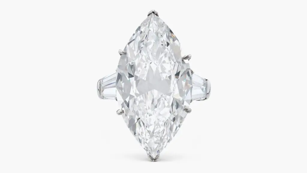 A Harry Winston piece, this one a ring with a marquise-shaped, 13.76-carat, D, internally flawless diamond center stone between two tapered baguette diamonds at Sotheby's image