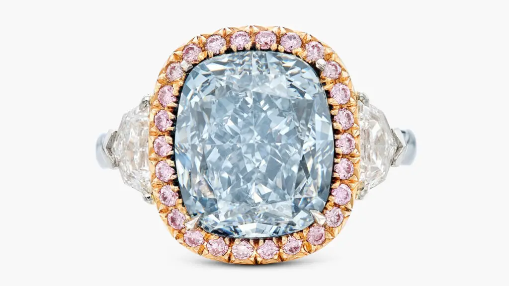 This ring centers a cushion modified brilliant-cut, 6.76-carat, fancy-greyish-blue, SI1 diamond, framed by round, pink-hued diamonds, between a pair of shield-shaped stones at Sotheby's image