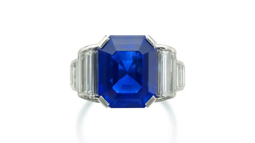 A ring with a step-cut, 10.43-carat Kashmir sapphire center stone between baguette-diamond shoulders at Sotheby's image