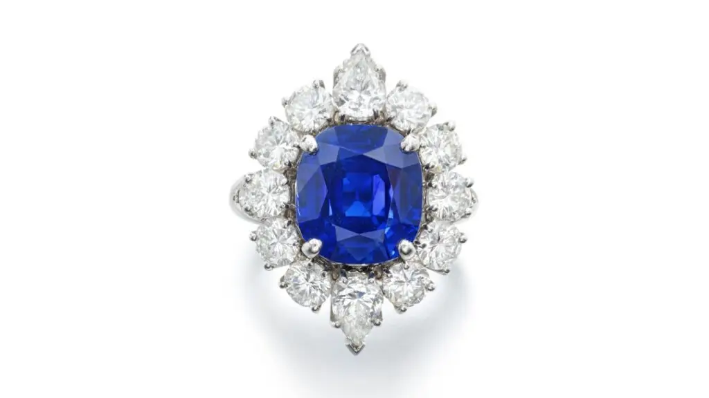 Van Cleef & Arpels ring features a cushion-shaped, 7.69-carat Kashmir sapphire within a border of pear-shaped and brilliant-cut diamonds at Sotheby's image