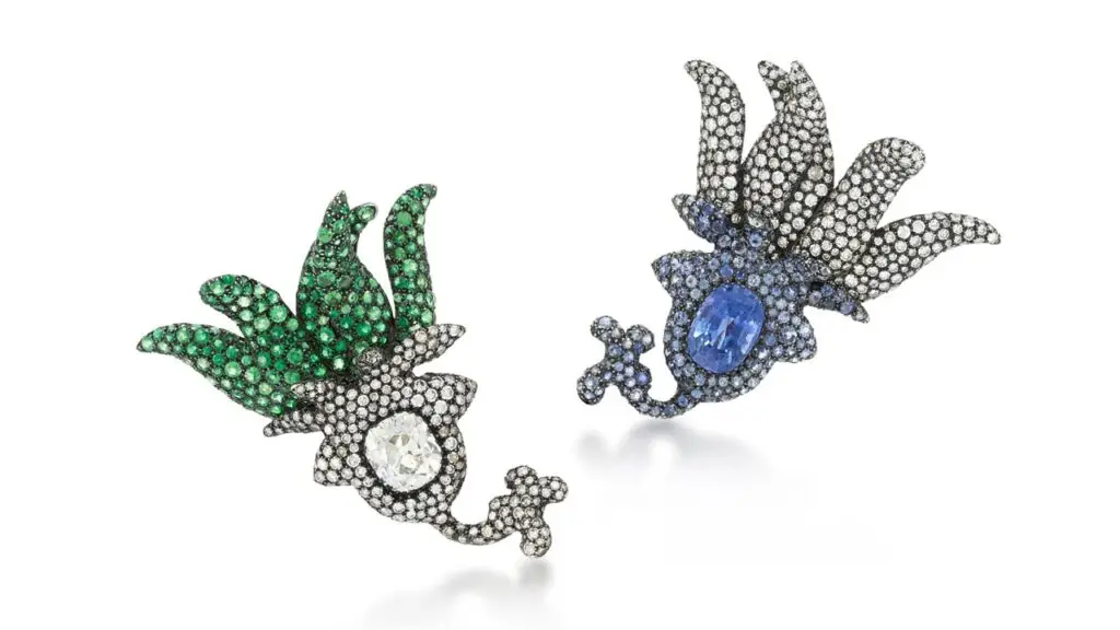 These JAR ear clips are another designer lot, featuring an oval sapphire in a pavé-set circular-cut sapphire frame and an old mine-cut diamond embellished with tsavorite garnets at Sotheby's image