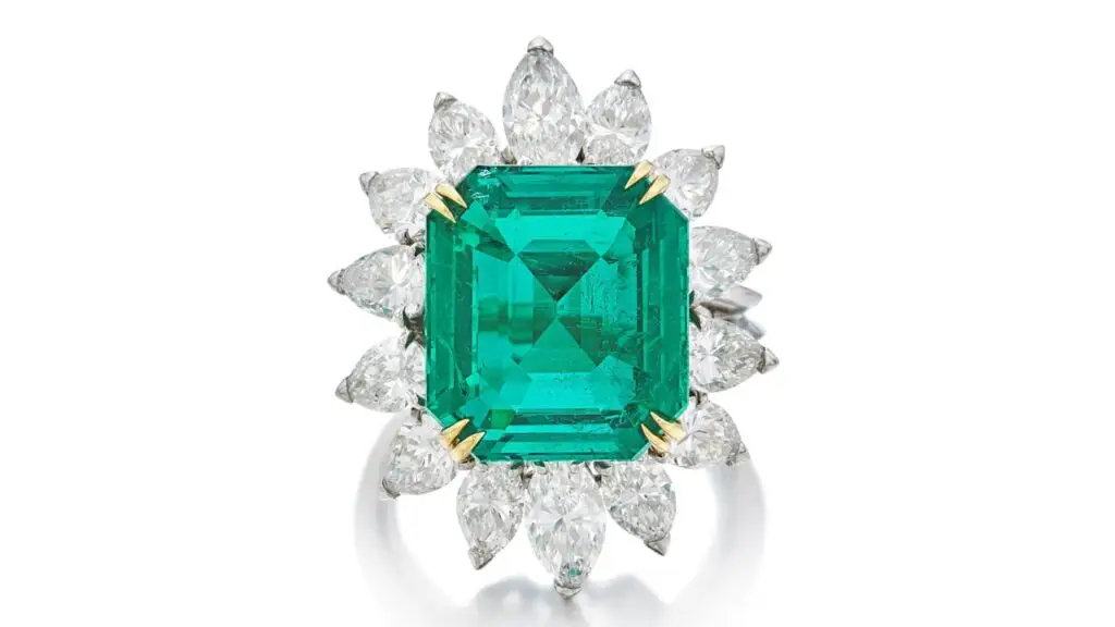 This Boucheron ring features an emerald-cut, 7.88-carat Colombian emerald with 14 pear- and marquise-shaped diamonds surrounding it at Sotheby's image