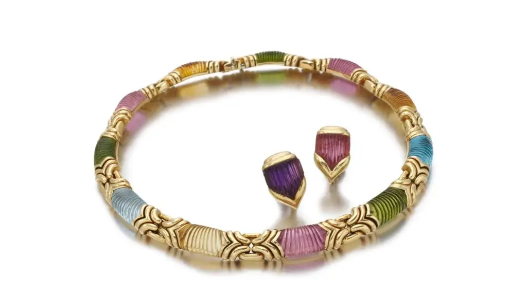 A Bulgari set comprising a necklace and pair of ear clips features carved tourmalines, peridots, citrines and topazes at Sotheby's image